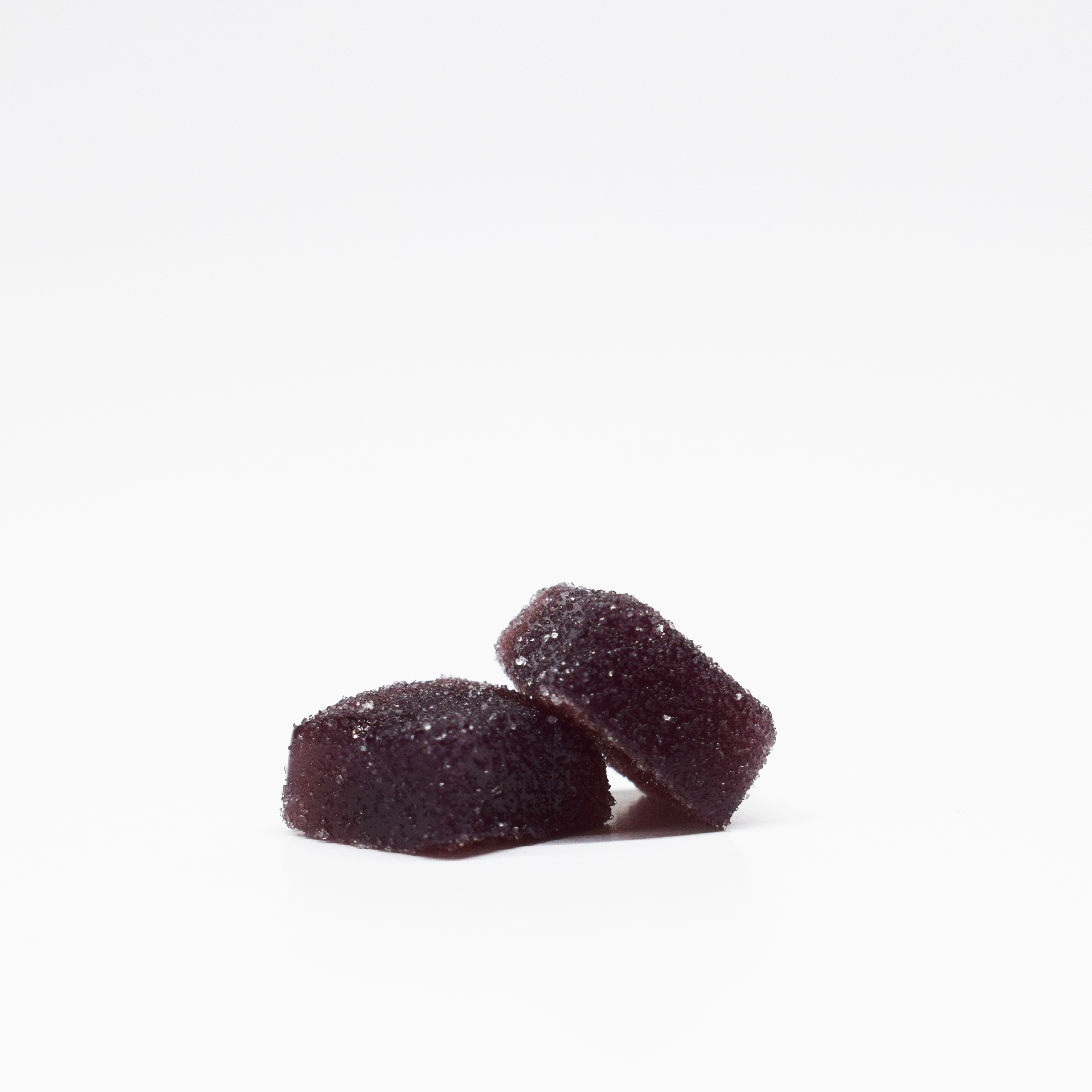 JOLLY 1:25 THC:CBD Blueberry Raspberry Gummies. Dark purple, square, sugar coated gummies